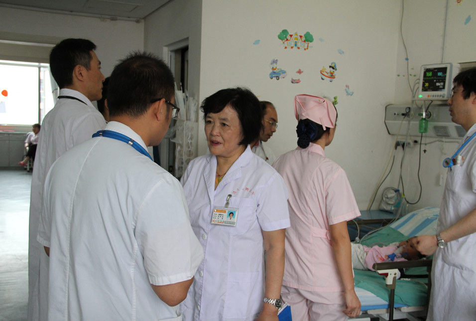 在儿科监护室，与主管医师沟通她所了解到的患者家属的思想动态及合理性的要求，提醒在今天查房时必须引起重视的环节。